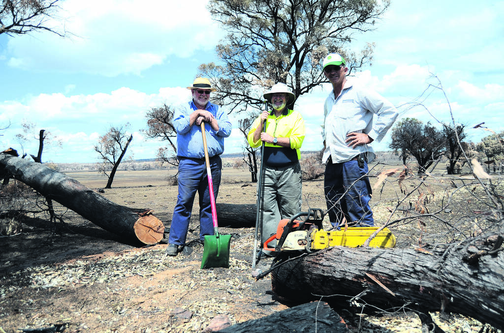 MATES IN NEED –  BlazeAid Volunteers David Staniforth and Glen Fletcher, and property owner Stirling Fergusson, ripping out damaged fencing. Photo: Elouise Hawkey/Daily Liberal