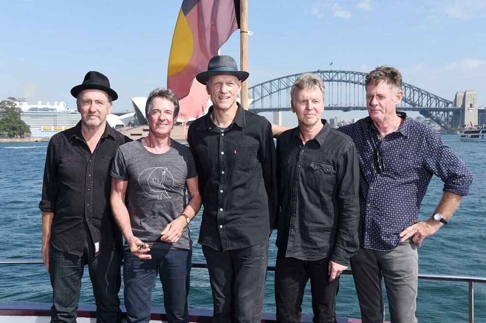 MIDNIGHT FEAST -  (l-r) Bones Hillman, Rob Hirst, Peter Garrett, Jim Moginie and Martin Rotsey of Midnight Oil on Sydney Harbour after announcing their world tour. Photo: Ryan Pierse/Getty Images