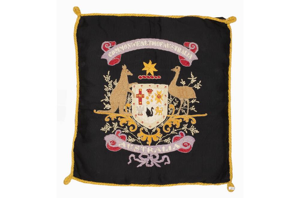 Part of a black cotton cushion cover depicting the Australian coat of arms embroidered by Lance Corporal Alfred Briggs (Albert Biggs), 20 Battalion, AIF. Courtesy of Australian War Memorial