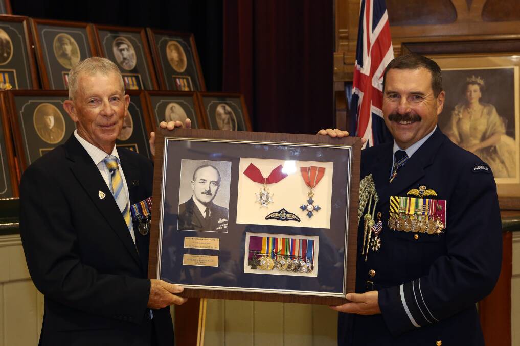 WAR HERO - Chief of Air Force, Air Marshal Leo Davies (right) presents RSL Rushworth Sub-branch president Bill Barlow with replica medals commemorating Air Vice-Marshal Frank McNamara.