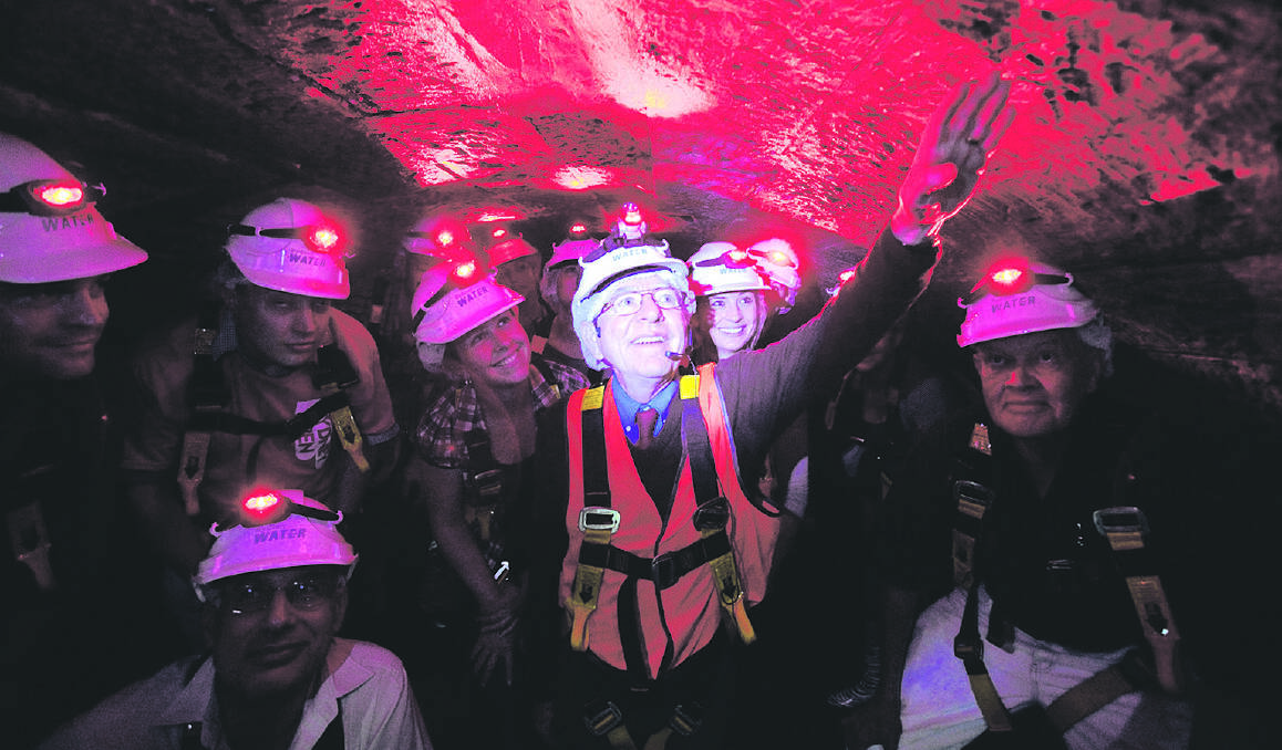 BENEATH THE CITY STREETS – Guide John Breen tells the story of  the Tank Stream to a group of lucky subterranean visitors. Photo:  James Horan