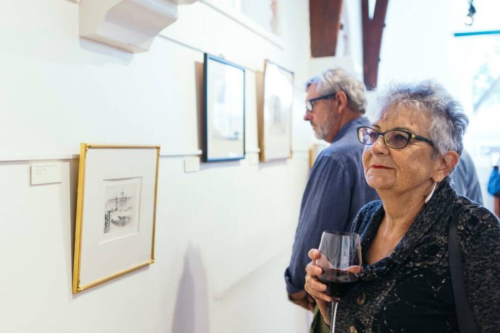 A visitor admiring the prints. Photo: Jason Reekie Photography.
