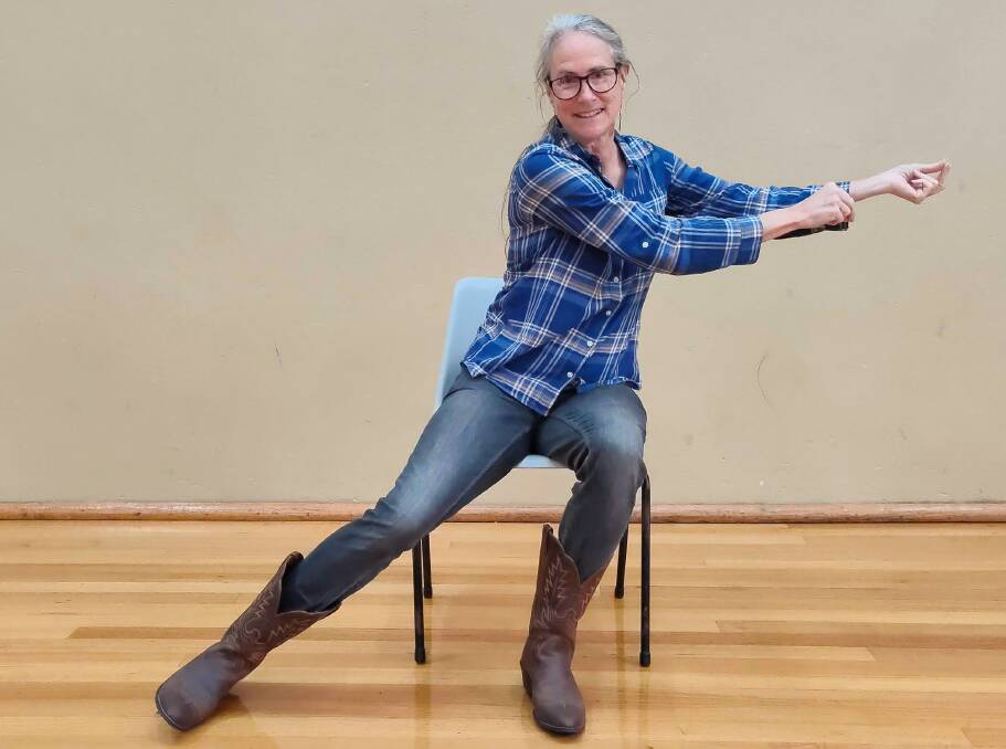 STAY SEATED: Laura Rittenhouse demonstrates the toe point to her line dancing class.