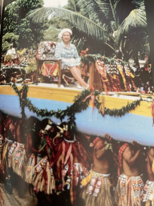 Queen Elizabeth is carried on a war canoe down the main street in Tuvalu during her South Pacific tour in 1982. Picture supplied