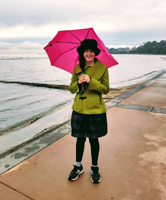 LADY WITH THE PINK UMBRELLA: Linda Neil on location at the Esplanade with her favourite hot pink brolly.