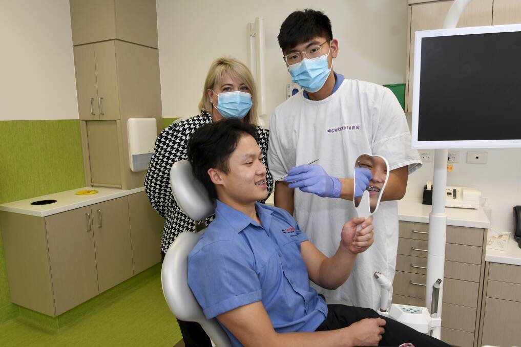 CHECK-UP: Dental operations director Jacqui Nolan with students Christopher Lee and John Do. Picture: Lachlan Bence