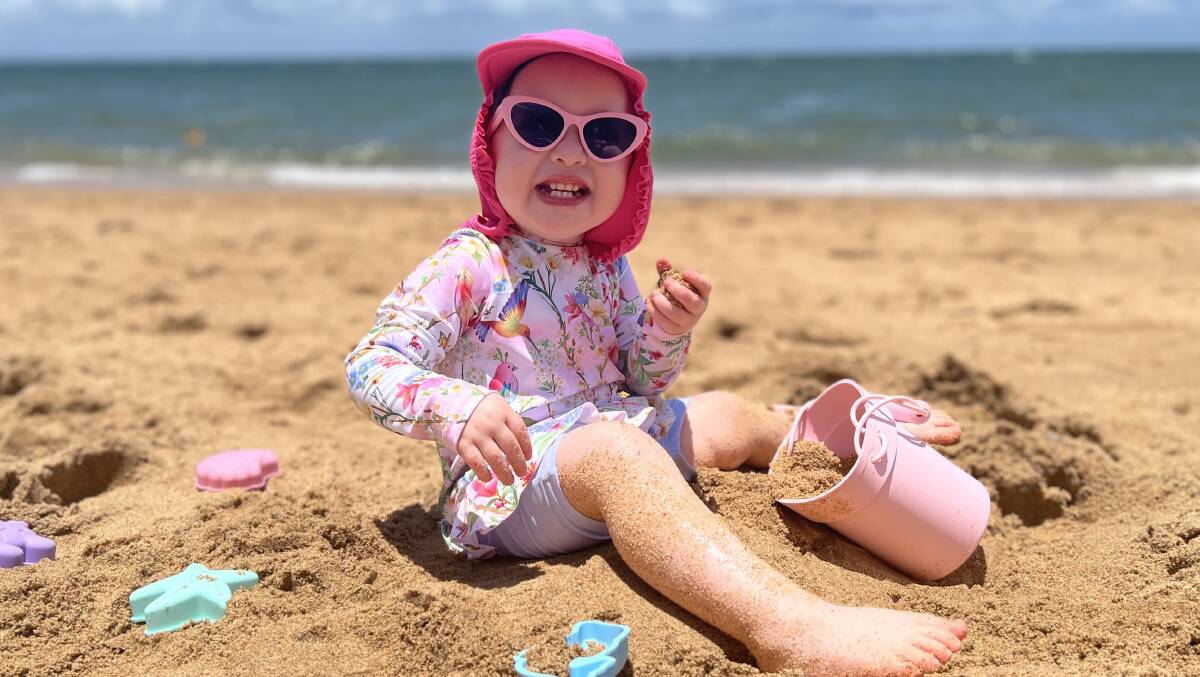 Lavinia Crowley plays it eye safe at the beach by slipping on a shirt, slapping on sunscreen, slapping on a hat and sliding on sunglasses. Picture supplied