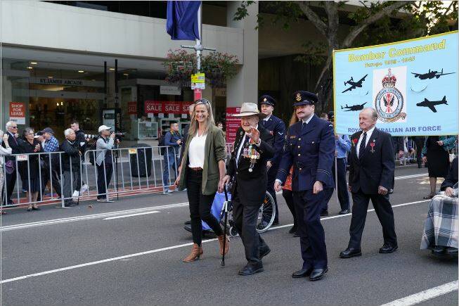 Ron Houghton (centre) with two of his grandchildren, Jo Houghton (left) and Flight Lieutenant Matthew Peate (right) at the Sydney Anzac Day march in 2021. Picture supplied