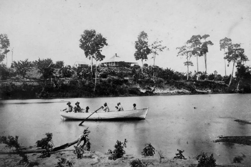 The Macknade sugar plantation viewed from the Herbert River, Ingham, in 1874, with men from the plantation in the rowboat. Wikimedia/State Library of Queensland
