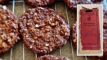 Main picture: Anzac Biscuits fresh out the oven. Inset: A copy of The South Australian Country Women`s Association's 'Calendar of Cakes - A cake a day for 365 days.' Pictures Therese Murray/supplied