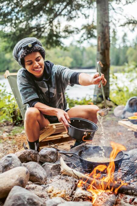 Natalie Rodriguez cooking at a lake in Ontario. Picture by Abigail Marie Rodriguez.