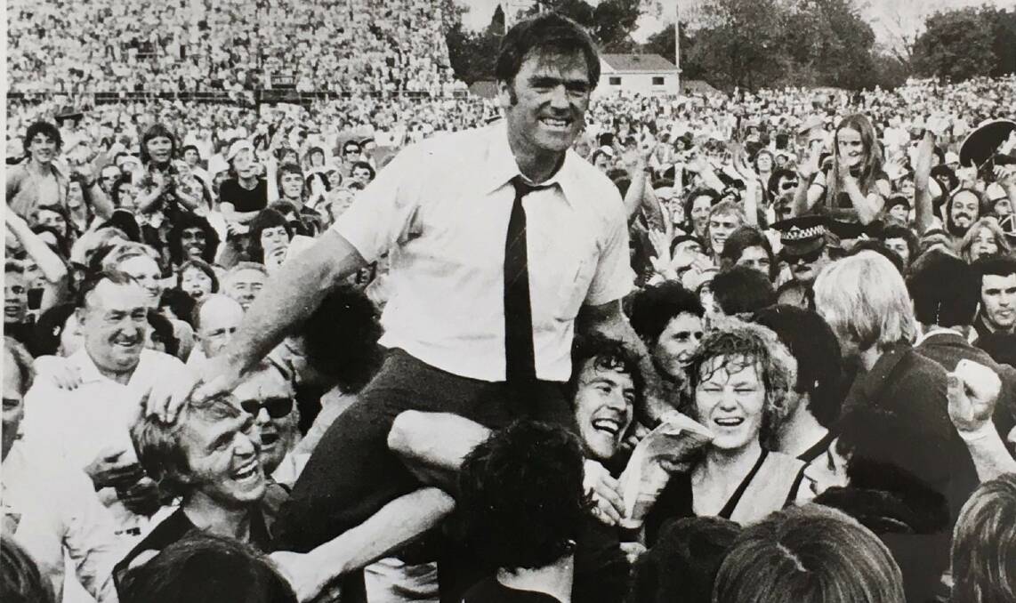Glenelg celebrates winning the 1973 premiership against North Adelaide, with Neil Kerley held up and his right hand touching Graham Cornes. Photo: SANFL.