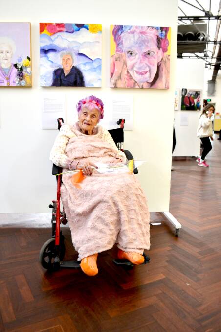 FABULOUS: Audrey Elliot was radiated at the exhibition opening. She is pictured with her portrait, by Joel Condo. Photo: The Senior.