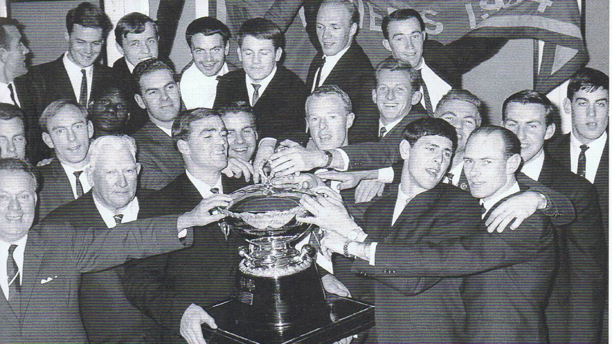 Neil Kerley holding the Seymour Hill Premiership Cup to celebrate South Adelaides 1964 premiership. Photo credit: SANFL. 