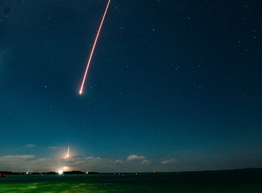 A NASA rocket lights up the night sky above the small town of Nhulunbuy in the Northern Territory as history is written. Picture by Cameron Hinzey. 