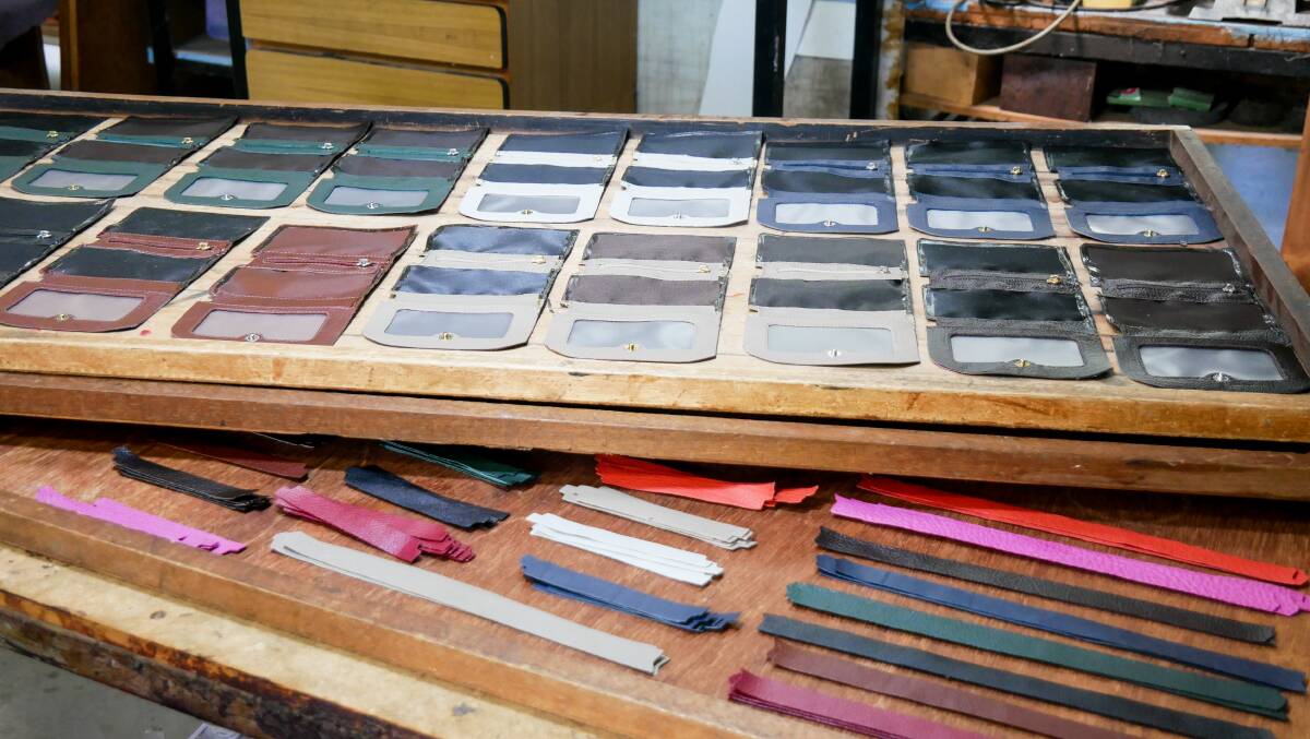Crocodile and leather wallets under construction in their workshop. 