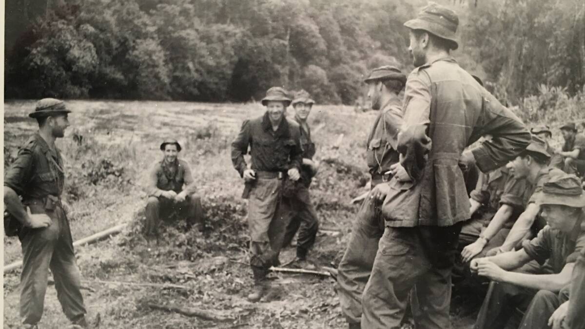 Ian Gollings (far left) briefing his platoon deep in the Malayan jungle. Picture: Supplied