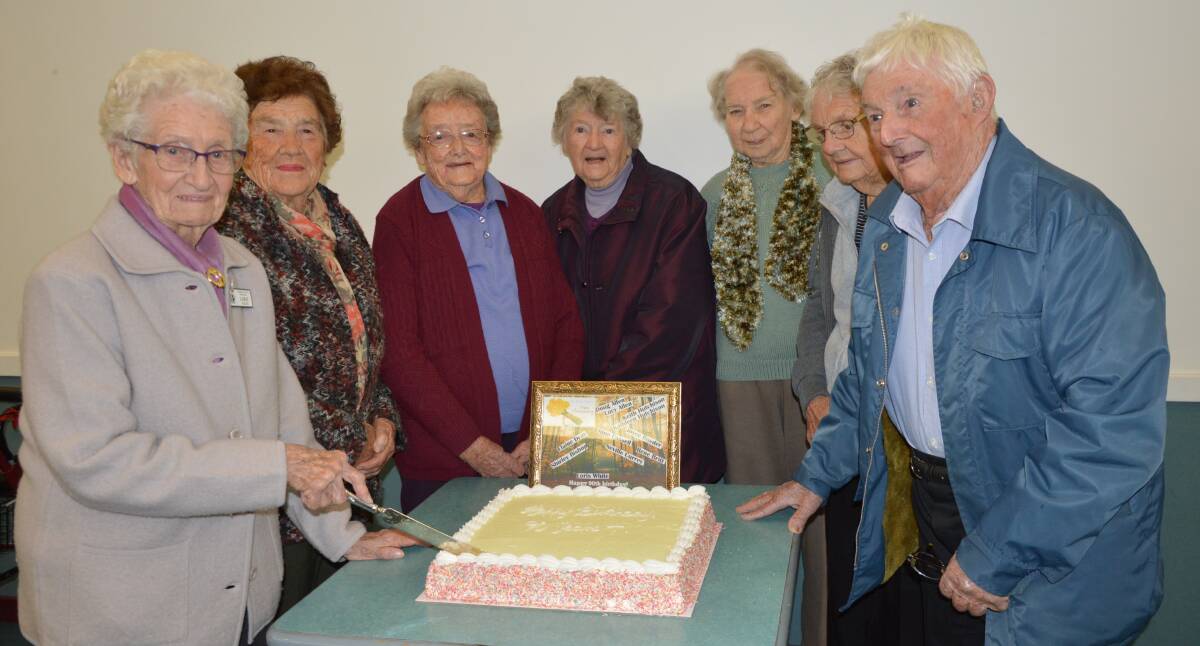 CELEBRATIONS: Loris White cuts the birthday cake in celebration of members who are 90 years or older, from left - Shirley Bishop, Rene Britt, June Cassell, Elaine Dray, Lucy and Doug Allen. Photo: Barbara Reeves.