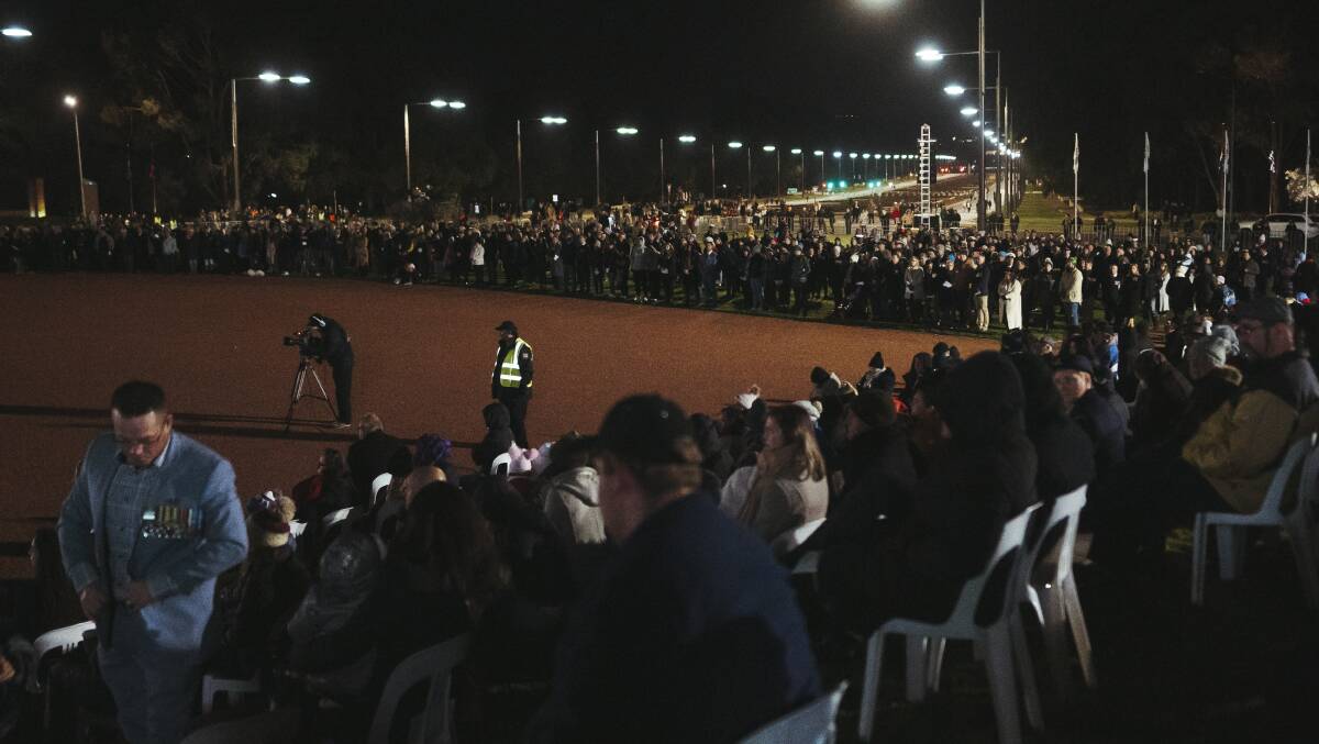 Those who could not get a ticket to the dawn service watched from barriers at the edge of the Australian War Memorial. Picture: Dion Georgopoulos
