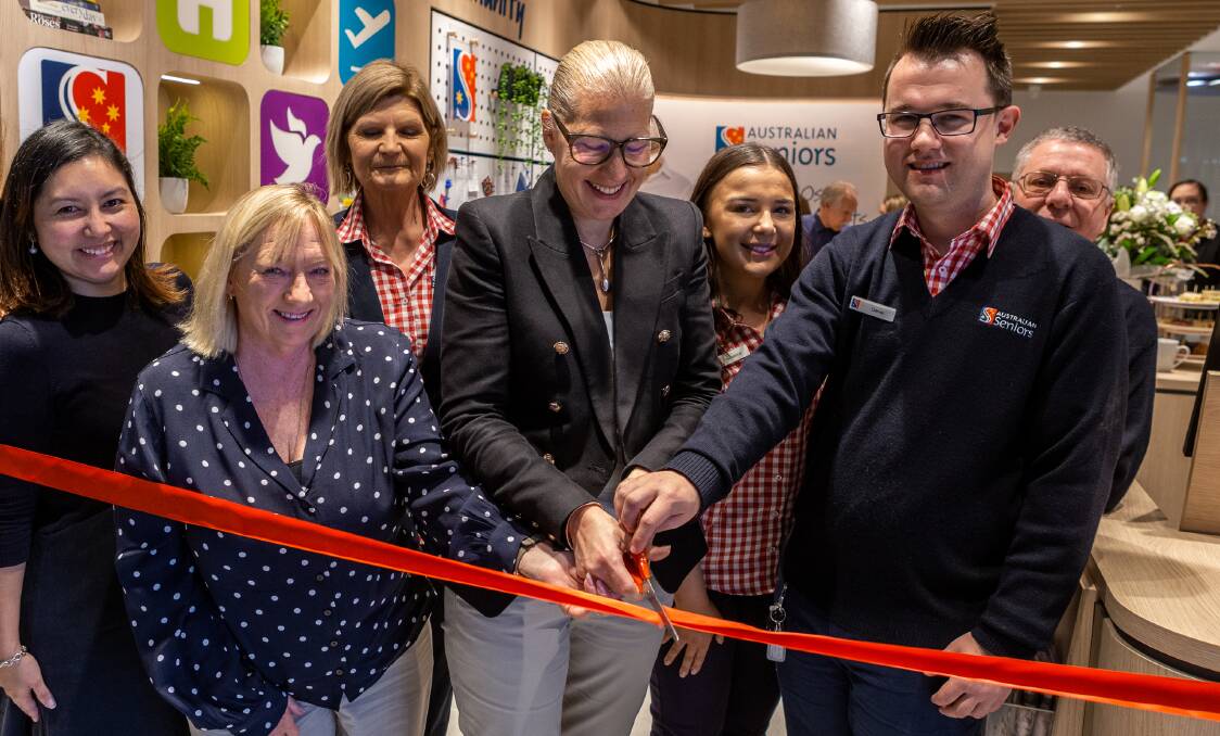 Greenstone chief customer officer Sarah Richards (centre, with glasses) cuts the ribbon at the new Australian Seniors Insurance Agency story in Lake Haven with Central Coast councillor Jillian Hogan and Lake Haven staff member Daniel Miller. In the back row (from left) are Australian Seniors' Lake Haven staff Katrina Foster, Julie Sammons, Jessica Collins and Bernard Player.
