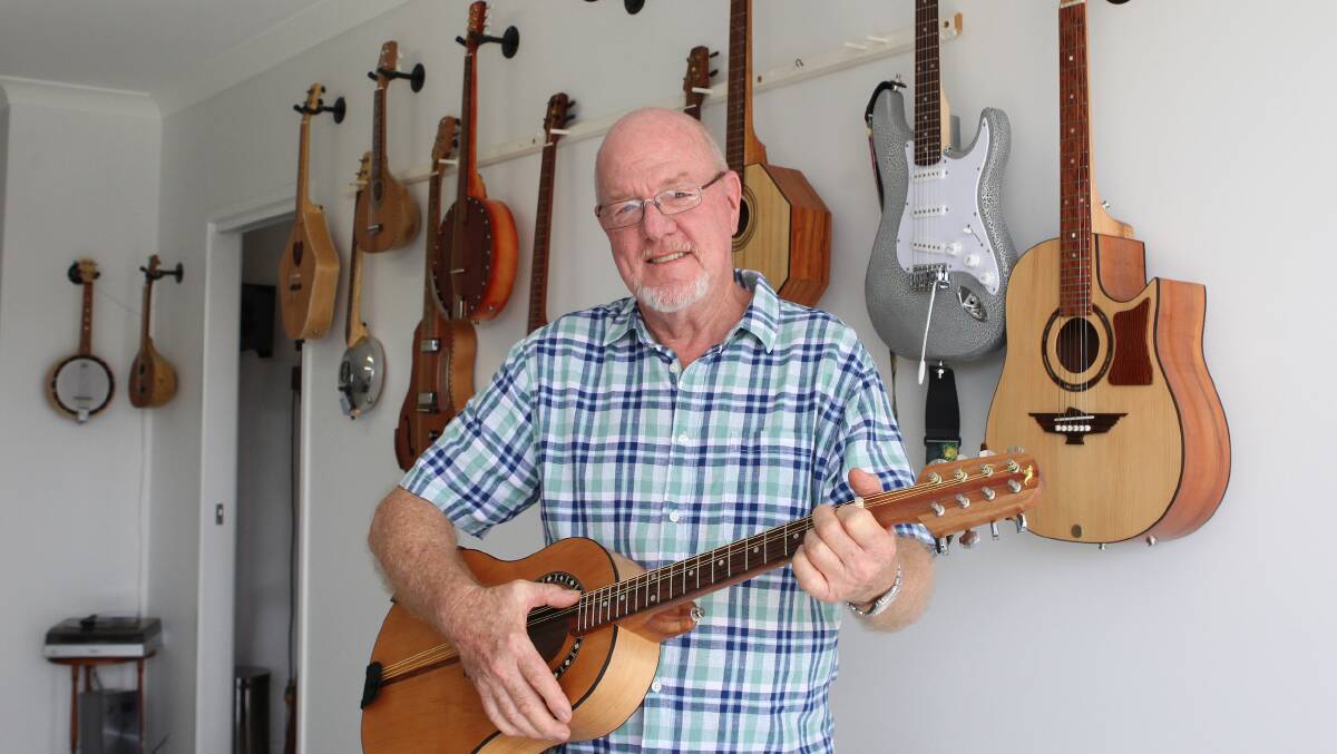 PLUCKY FELLOW: Retiree Howard Cox with some of the instruments he has made on display in his Sunshine Coast home. 