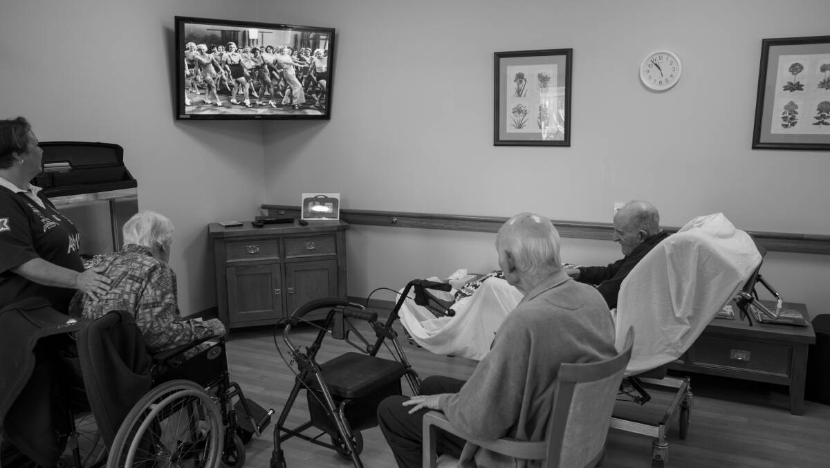 TUNING IN: Residents at Anglicare Symes Thorpe in Toowoomba listen to Silver Memories through the TV. Photo: Russell Shakespeare.