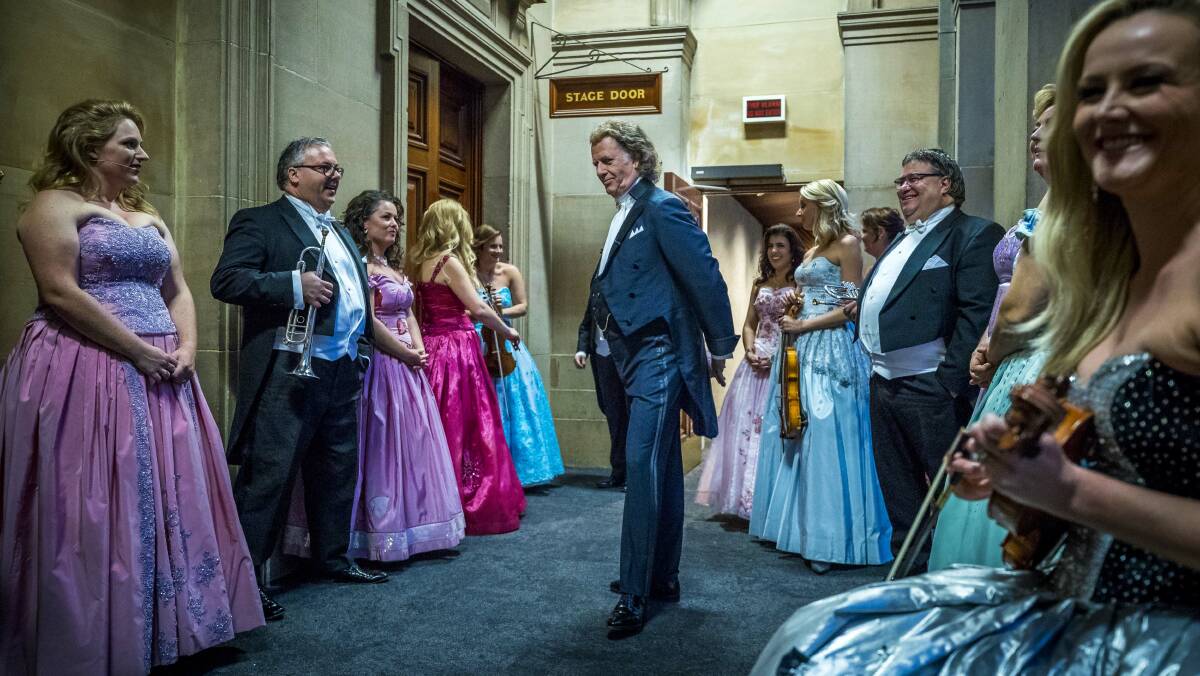 TEAMWORK: Andre Rieu prepares backstage with members of his orchestra and entourage. 