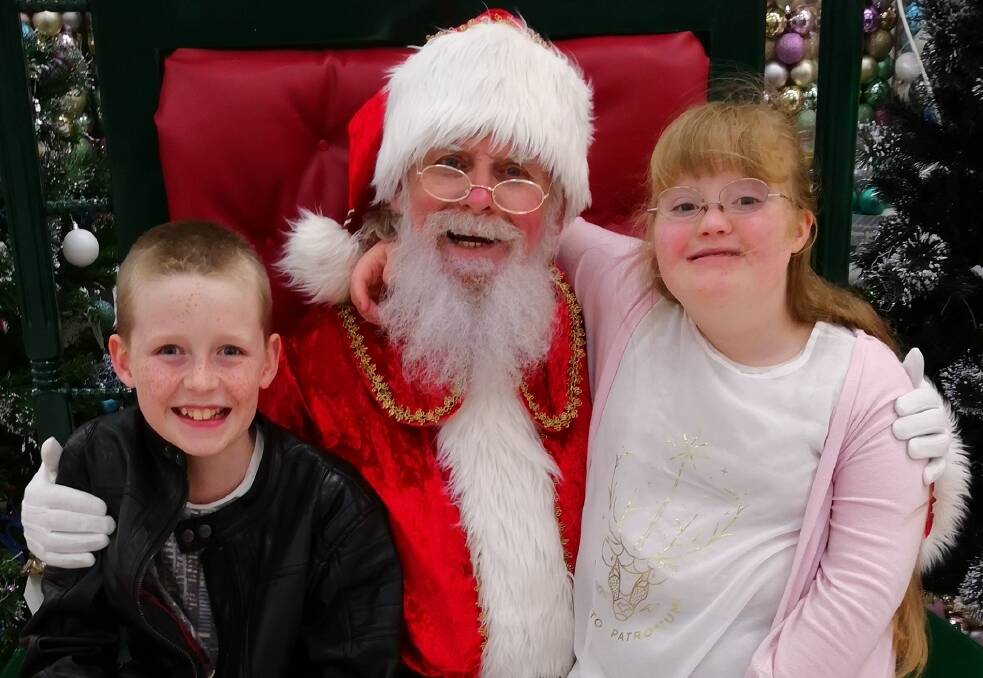GROWING FRIENDSHIP: Twins Caleb and Remy have been visiting Santa Ian since 2007, when they were just seven months old. 