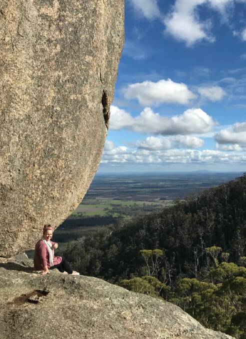 South Australia visitor Carolyne Jasinski rests at the top of Castle Rock after the steep climb.