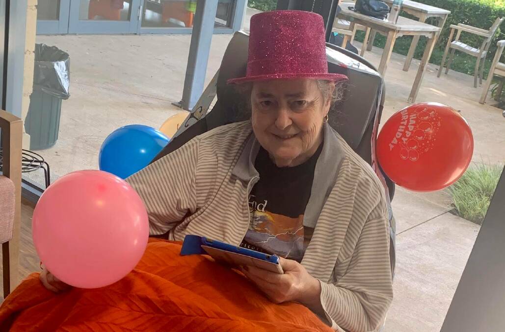 Benetas aged care resident Judith Evans reading a birthday message. 