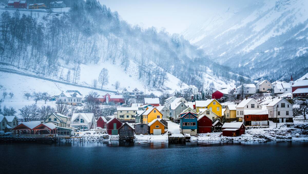 These wooden huts on the banks of a fjord are a typical scene in Norway.