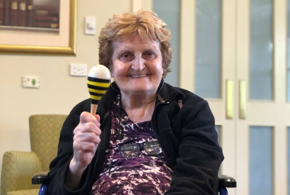 SHAKE IT: Bupa Greensborough resident Josie in a music therapy session. 