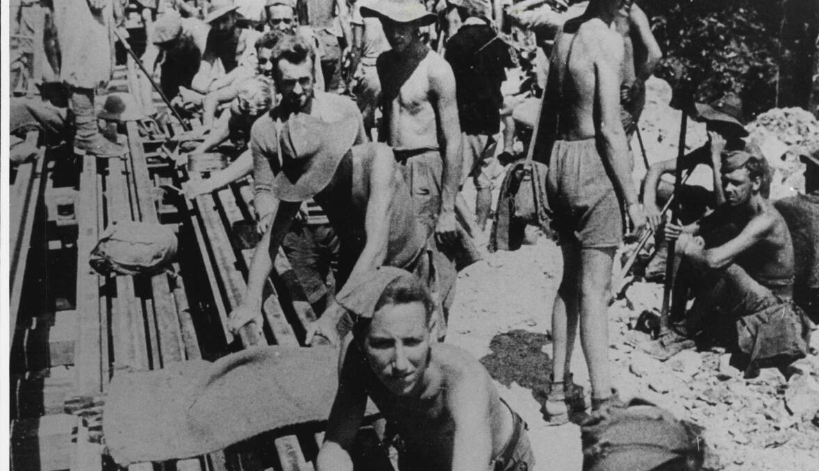 'WE BECAME SLAVES': A photo taken by the Japanese shows allied prisoners of war at work on the Burma Railway in Thailand. Photo: Australian Broadcasting Commission.