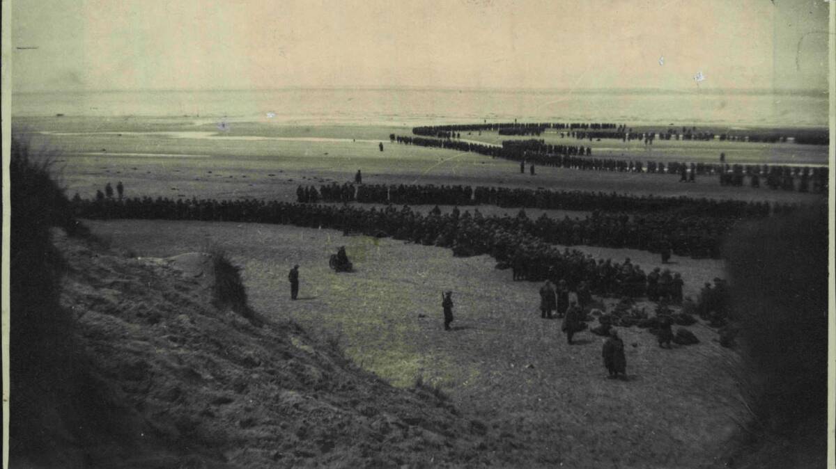 EVACUATION: British and French troops waiting on the dunes at Dunkirk to be picked up by destroyers to bring them back to England. Photo: Supplied.