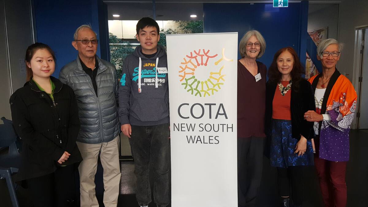 HERE TO HELP: COTA NSW Aged Care Navigators Trial coordinator Mary Bills (right of COTA sign) with volunteers at the Ashfield hub.