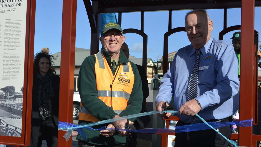 CUT: Acting president of SteamRanger Andrew McDonough and City of Victor Harbor mayor Graham Philp cut the ribbon to open the railway turntable. Photo: Victor Harbor Times