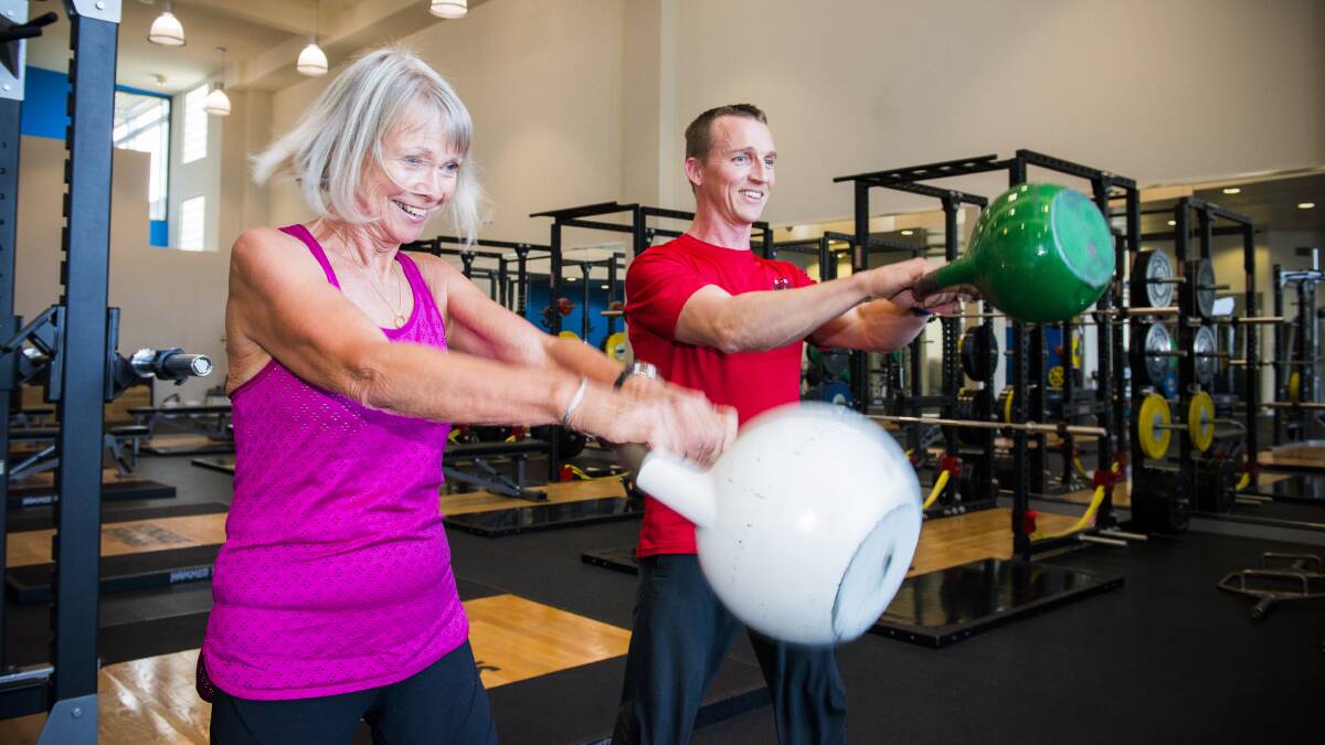 IN THE FAMILY: Physiotherapist and PhD candidate Neil Meigh doing kettlebell swings with with his mum Anthea Meigh, 70.