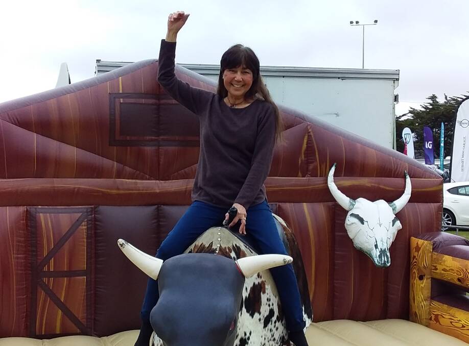 SECOND CHANCE: Joanne Galliher has a go at mechanical bull-riding at the Bothwell BushFest in 2018, just 19 months after her lung transplant.