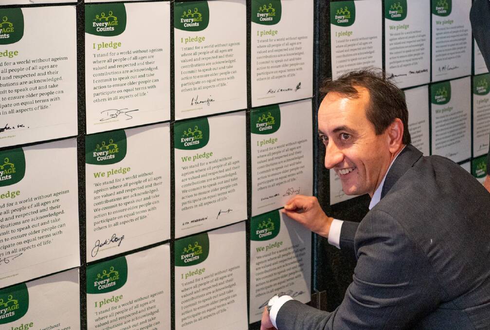 Wentworth Liberal MP David Sharma signs the EveryAGE Counts pledge at the exhibition, aimed at challenging perceptions of ageing.