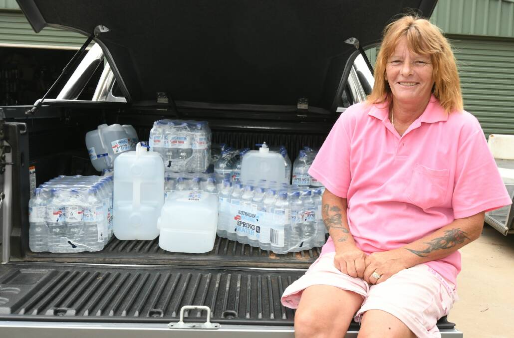 READY TO GO: Maree Glohe with some of the donated water. Photo: CARLA FREEDMAN 0106cfdrought1