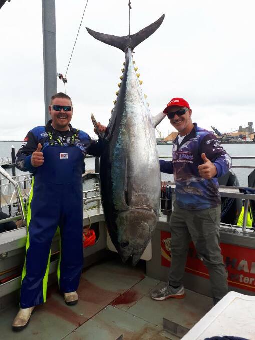 REEL BIG: Reel Time Charters' Matt Cini and his co-worker with the 168-kilogram Southern Bluefin Tuna. 