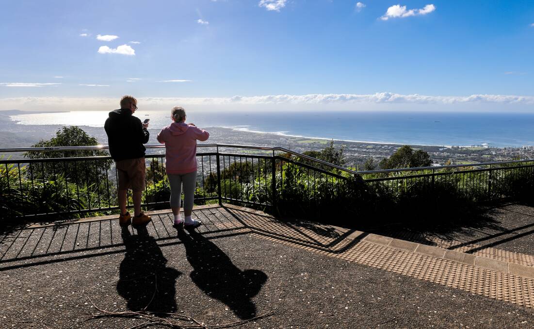 An older couple take in the view of the NSW South Coast from Mount Keira lookout, near Wollongong. Picture by Adam McLean.