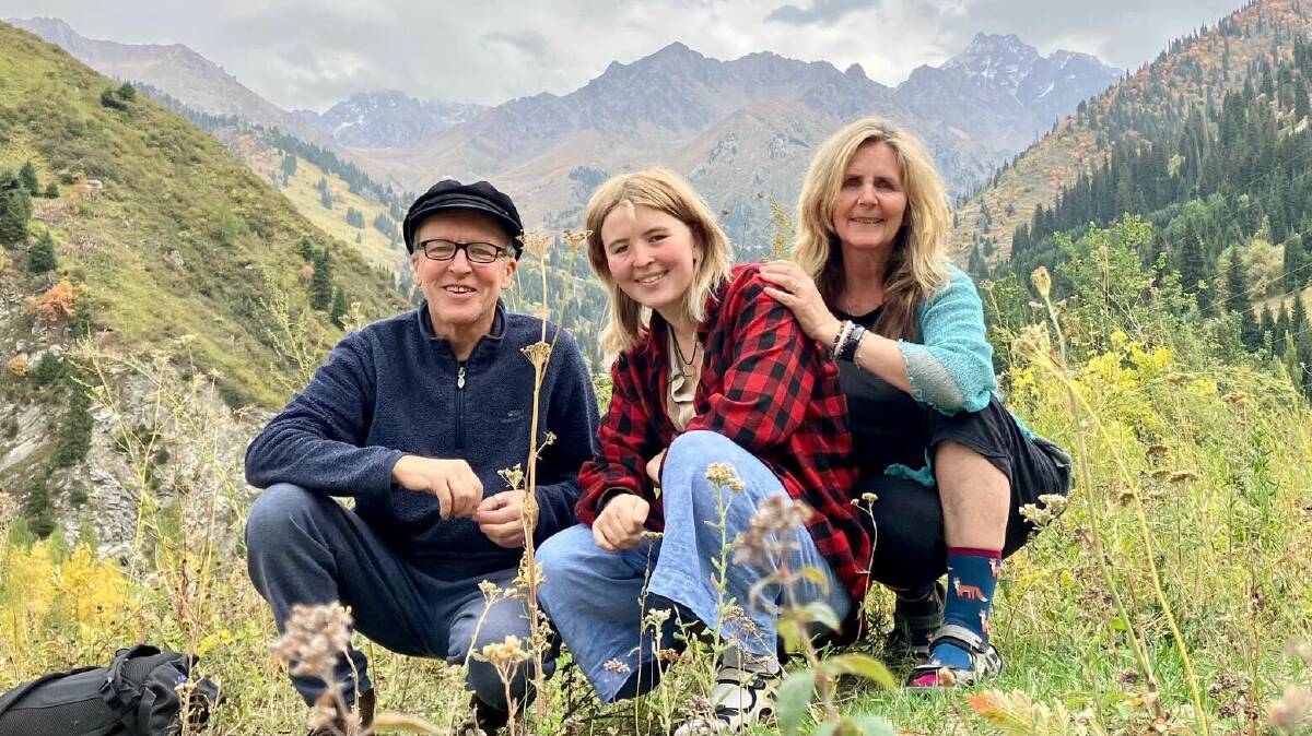 Environmentally conscious travellers Theo Simon and wife Shannon Coggins and their daughter Rosa, posing for a photo in front of mountains of Kazakhstan. Picture supplied.