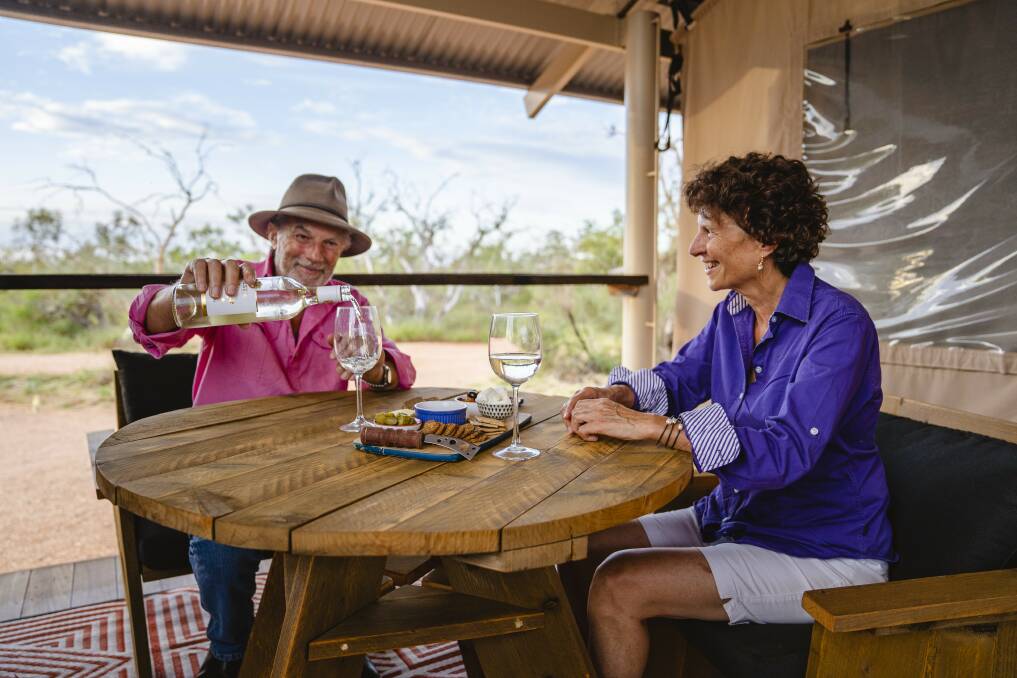 A couple enjoy a wine and cheese platter at Bullara Station, in WA's Exmouth Gulf. The iconic destination won three gongs in the Grey Nomad Awards. Picture supplied by Western Australia Tourism.