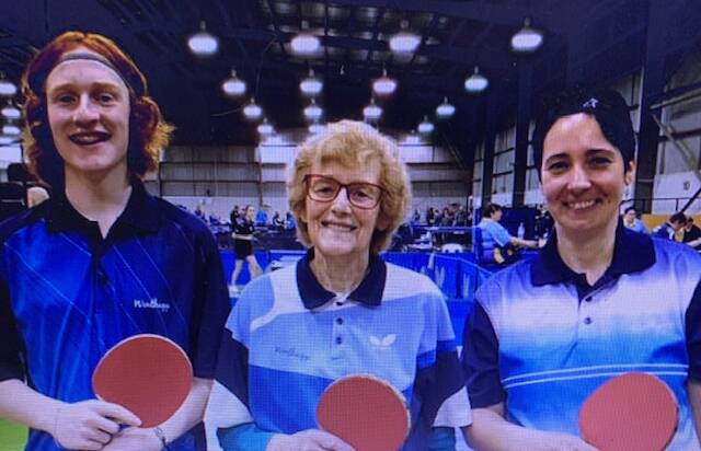 NET GAINS: Nancy Pattinson (centre) says table tennis is the perfect game for seniors who want to get more exercise, are bored, or looking to make new friends. Also pictured are junior players On the left is teenager Callum Smith-Martin and Tanja Kahl. 