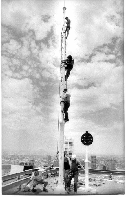 UP AND DOWN: Workers erecting one of Fine Music Sydney's original signal towers at the AMP Centre in 1977.