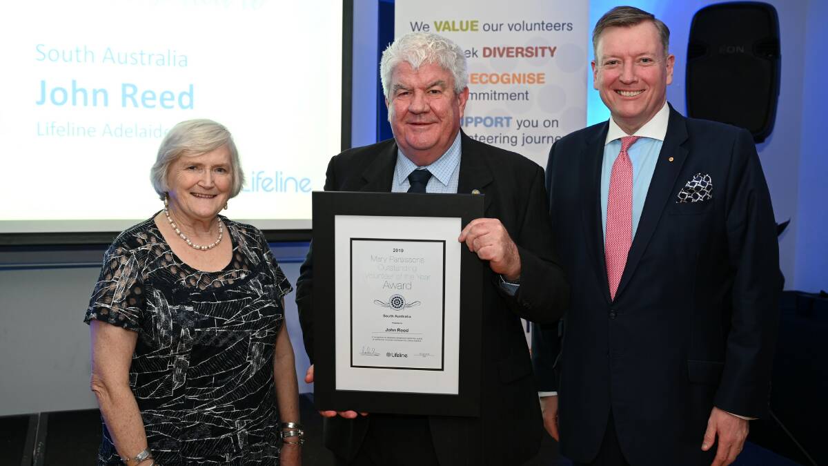 HELPING HAND: Lifeline Australia's volunteer of the year John Reed (centre) with Mary Parsissons and Lifeline Australia chairman John Brogden.