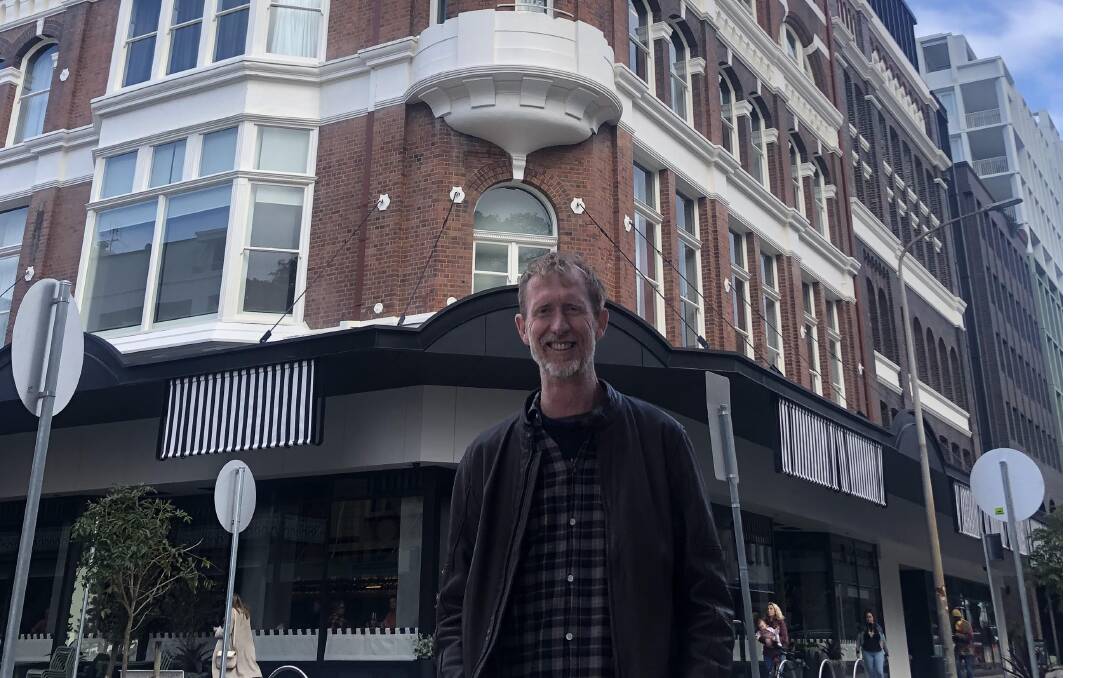 Matthew Bailey is part of a team of researchers from Macquarie and RMIT Universities which is compiling a study on the history of department stores in Australia. Matthew is pictured outside the old Scott's Ltd building in Newcastle, which would later become the site of a David Jones and is now a QT Hotel. Picture supplied 