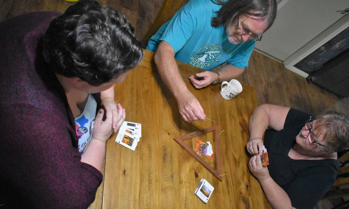 GOOD DEAL: The Crossroads Convention offers the opportunity for people to learn new games, play old favourites and make some great new friends. Pictured from left, Lisa, Roger and Lorri Lambert playing a game of cribbage.