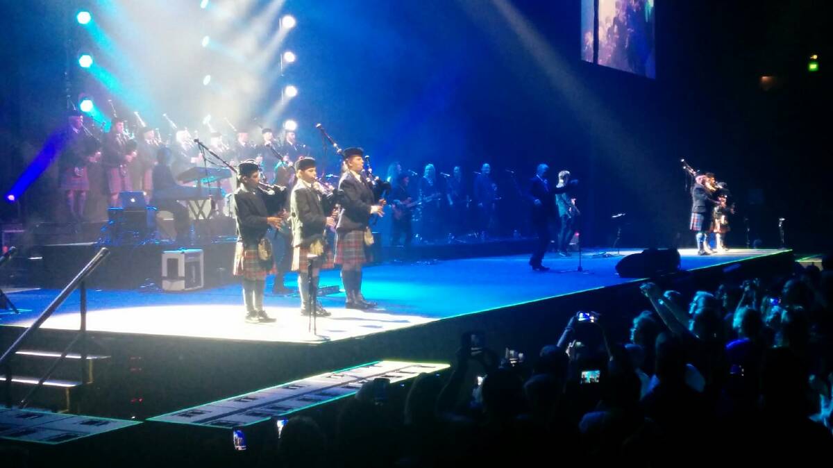 THE BIG STAGE: Barry and other pipers performing with John Farnham.